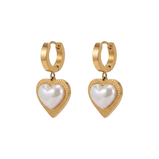 Gold hoop earrings with heart-shaped pearl drops on a white background