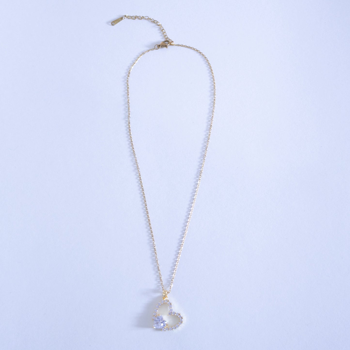 Necklace with a heart-shaped pendant on a light blue background