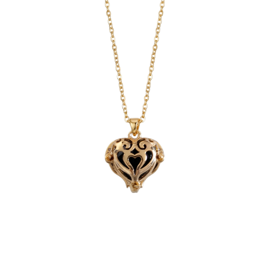 Gold heart-shaped necklace on a white background