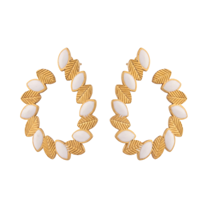 Gold hoop earrings with white stones on a white background