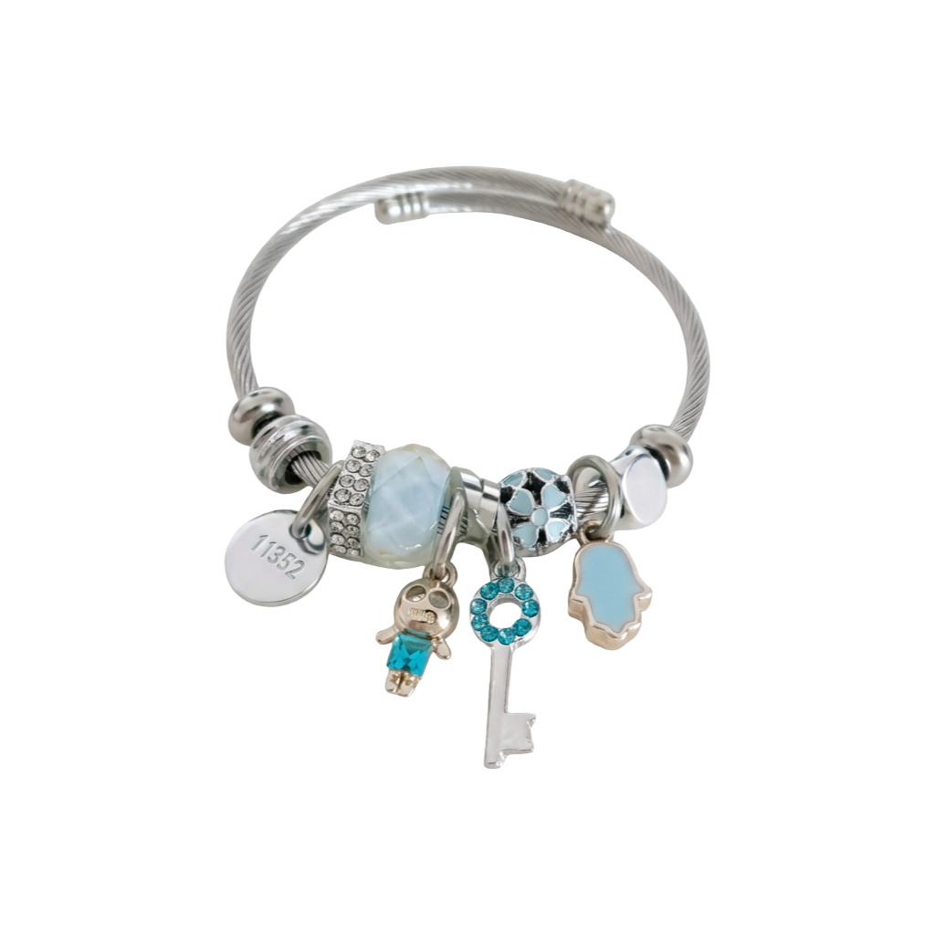 Silver bracelet with various charms on a white background