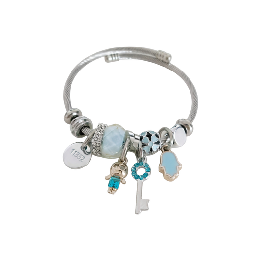 Silver bracelet with various charms on a white background