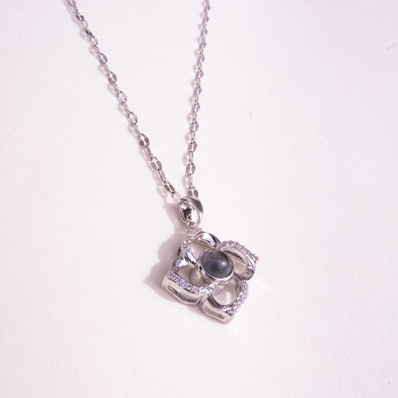 Silver necklace with a pendant on a white background