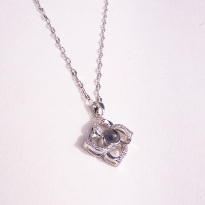 Silver necklace with a pendant on a white background