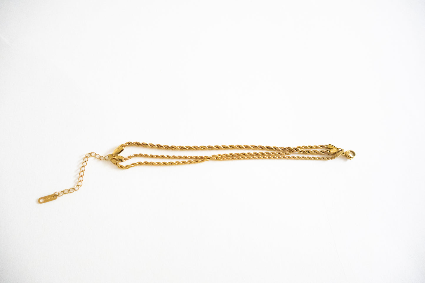 Gold chain bracelet on a white background