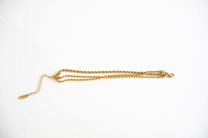 Gold chain bracelet on a white background