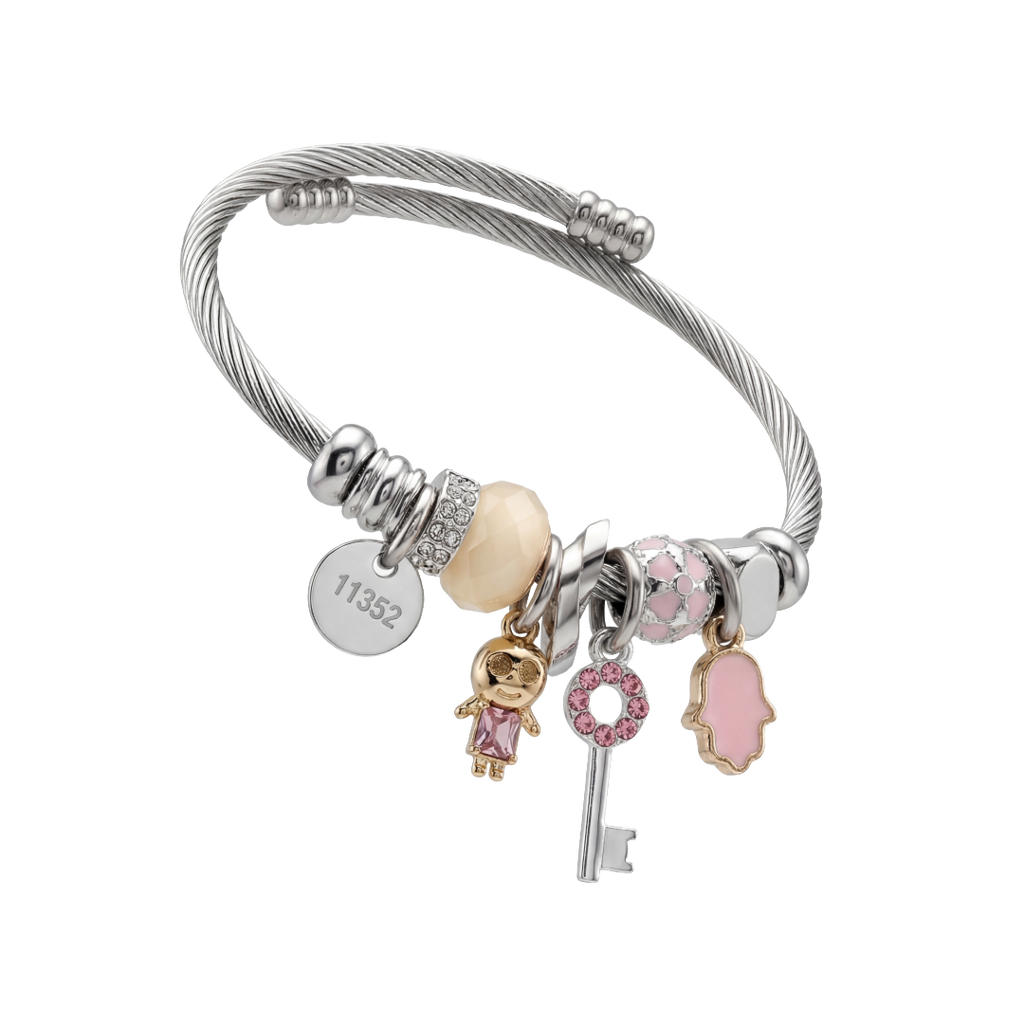 Silver bracelet with various charms on a white background