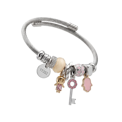 Silver bracelet with various charms on a white background