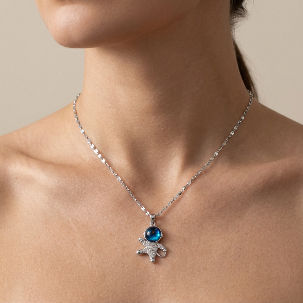 Necklace with a pendant featuring a blue gemstone worn by a person.