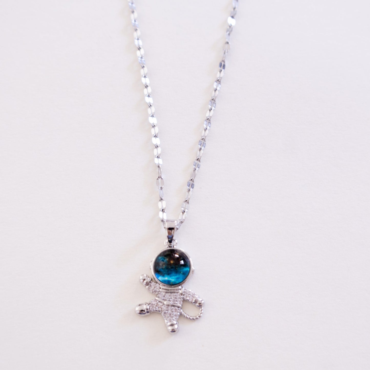 Necklace with a blue gemstone pendant on a white background
