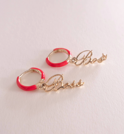 Gold hoop earrings with red accents and 'Boss' inscription on a light gray background