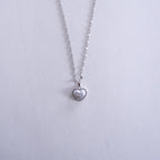 Heart-shaped pendant necklace on a light gray background