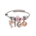 Bracelet with various charms including a dolphin, moon, and shell on a white background
