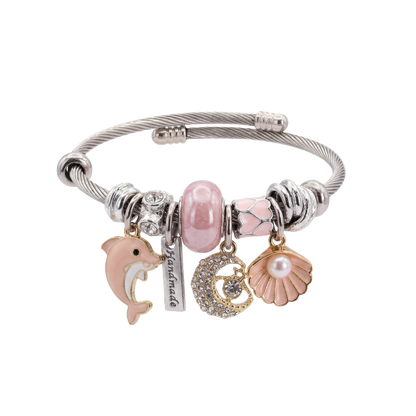 Bracelet with various charms including a dolphin, moon, and shell on a white background