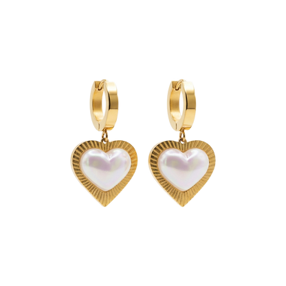 Gold heart-shaped earrings with pearl center on a white background