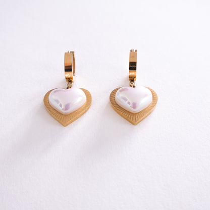 Heart-shaped earrings with gold and white design on a white background