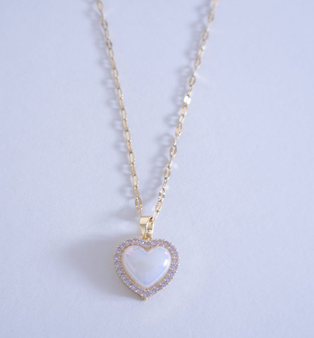 Heart-shaped pendant necklace on a light purple background