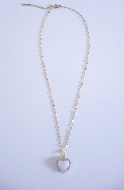 Necklace with a heart-shaped pendant on a light purple background