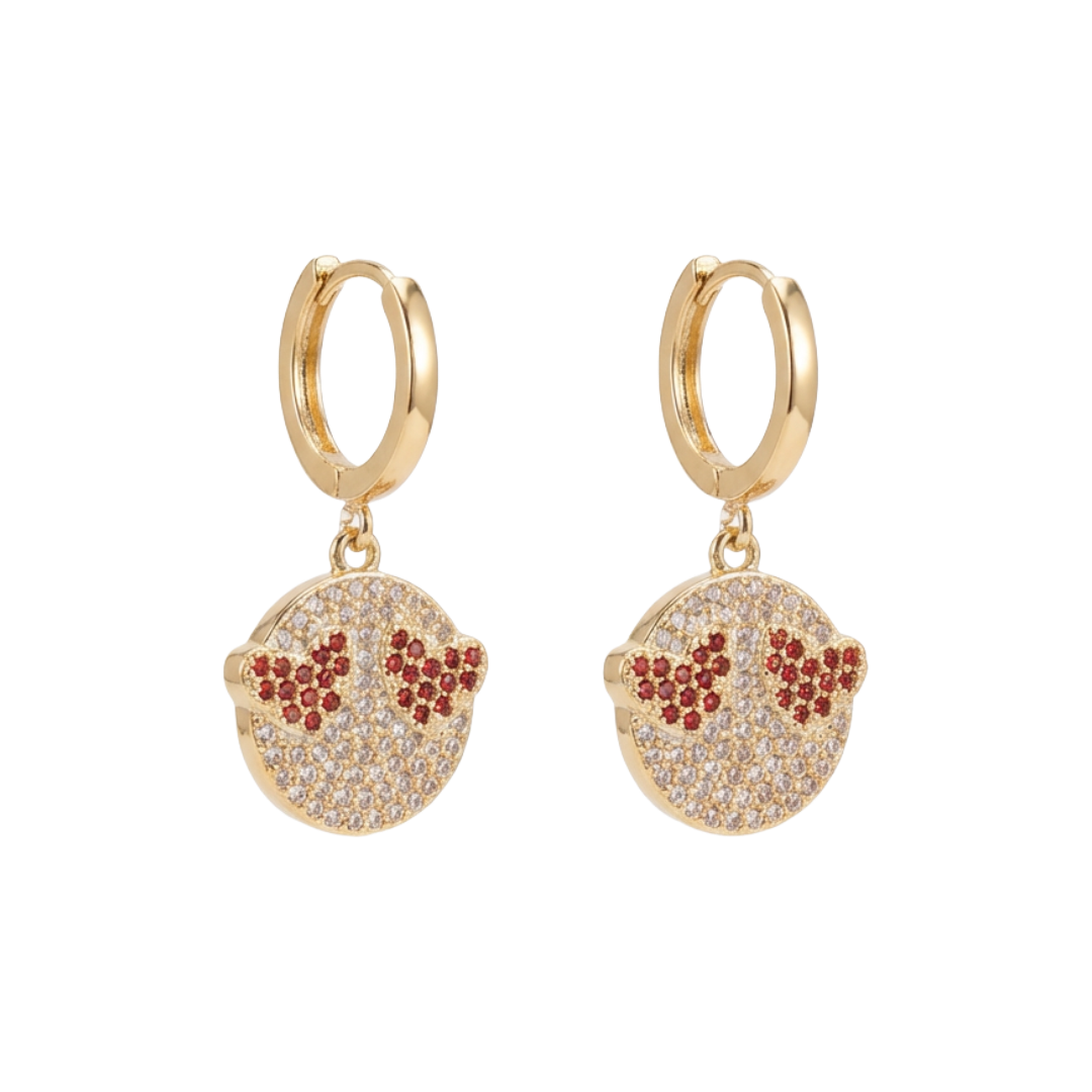 Gold hoop earrings with circular charms featuring red and clear stones on a white background