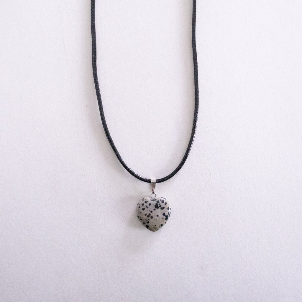 Necklace with a heart-shaped dalmatian jasper pendant on a white background