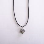 Necklace with a heart-shaped dalmatian jasper pendant on a white background