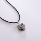 Necklace with a dalmatian jasper heart pendant on a white background