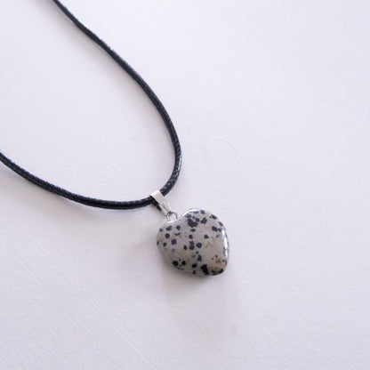 Necklace with a dalmatian jasper heart pendant on a white background