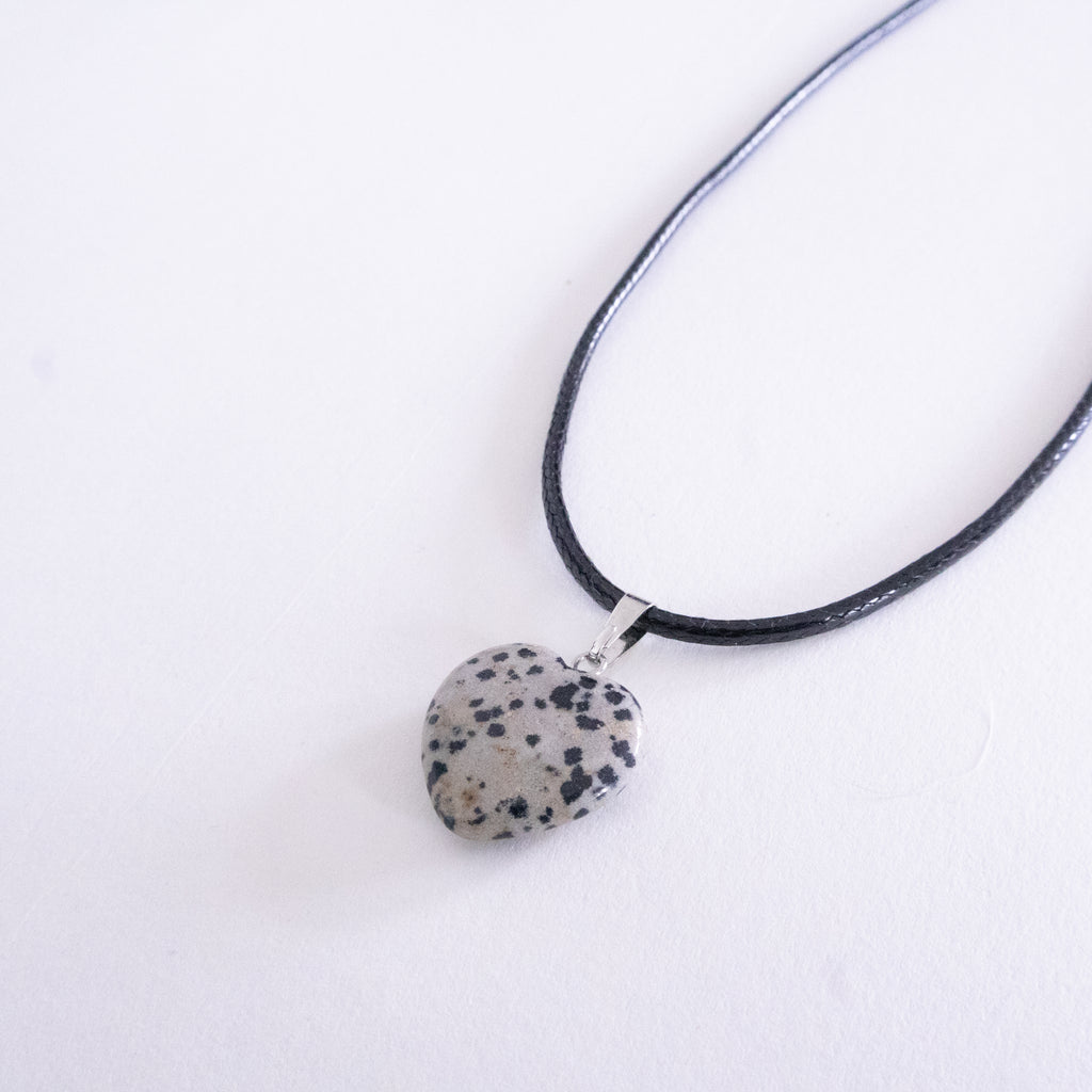 Necklace with a dalmatian jasper pendant on a white background