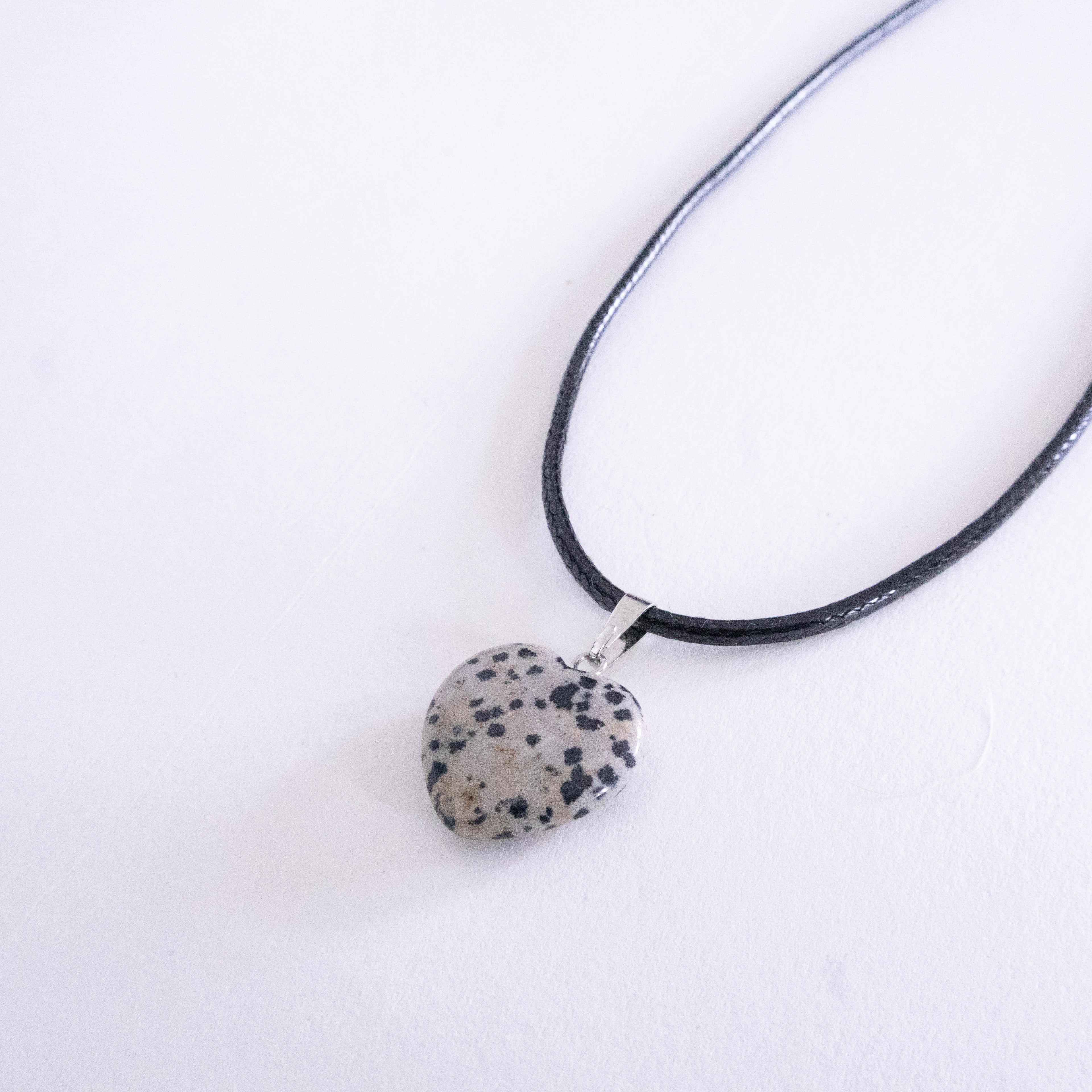 Necklace with a dalmatian jasper pendant on a white background