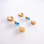 Gold hoop earrings with blue and clear bead charms on a white background