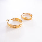 Gold hoop earrings on a white background