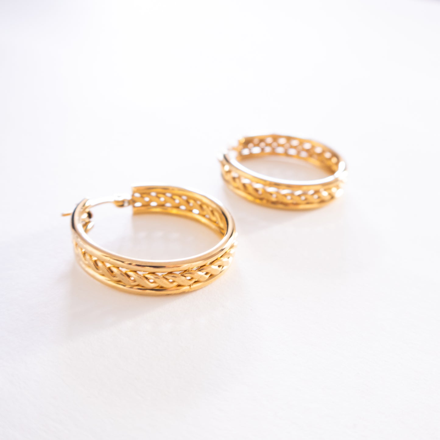 Gold hoop earrings on a white background