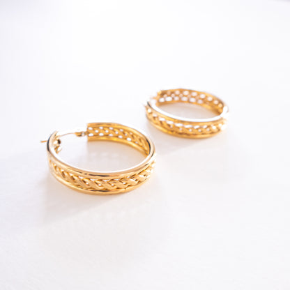 Gold hoop earrings on a white background