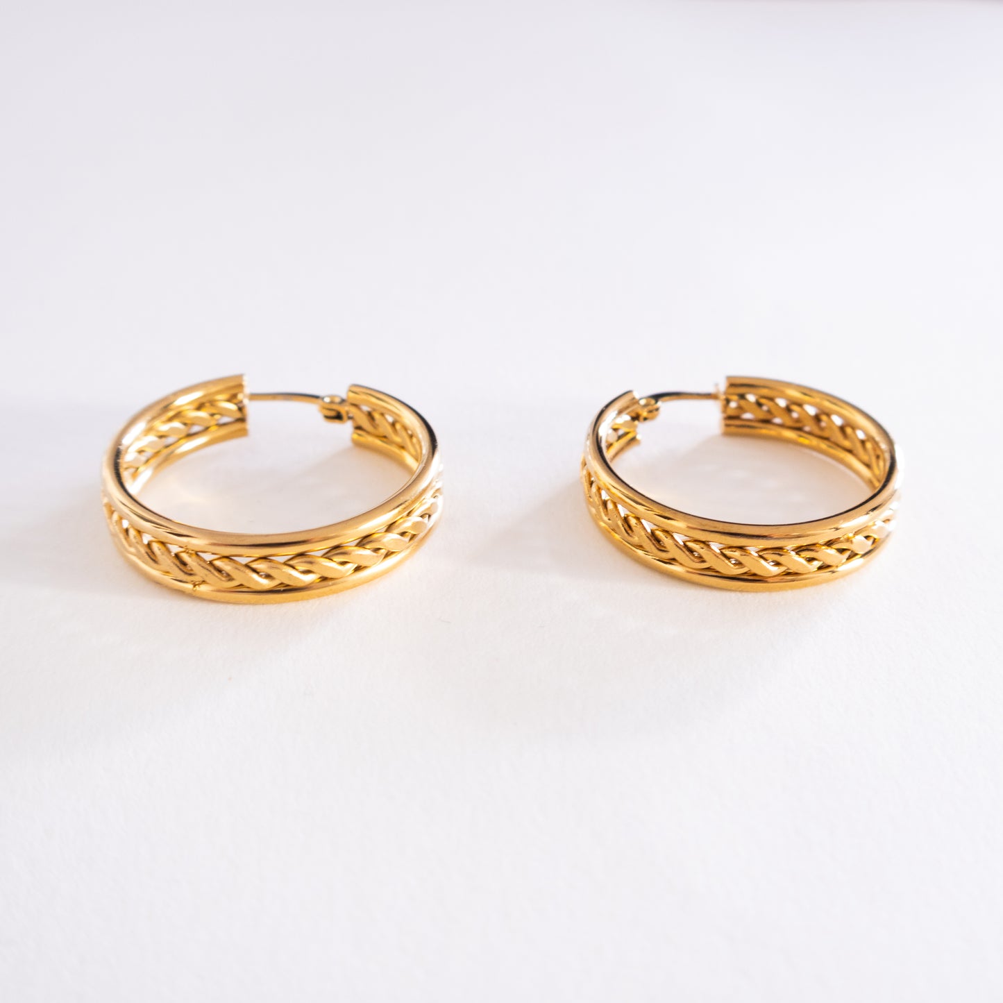 Pair of gold hoop earrings on a white background