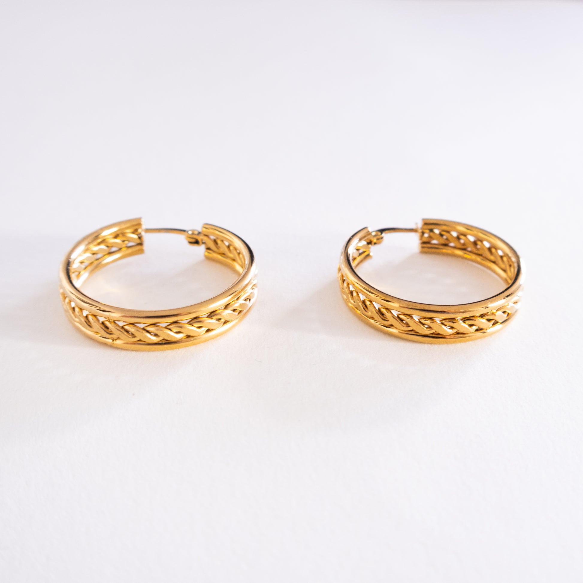 Pair of gold hoop earrings on a white background