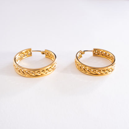 Pair of gold hoop earrings on a white background
