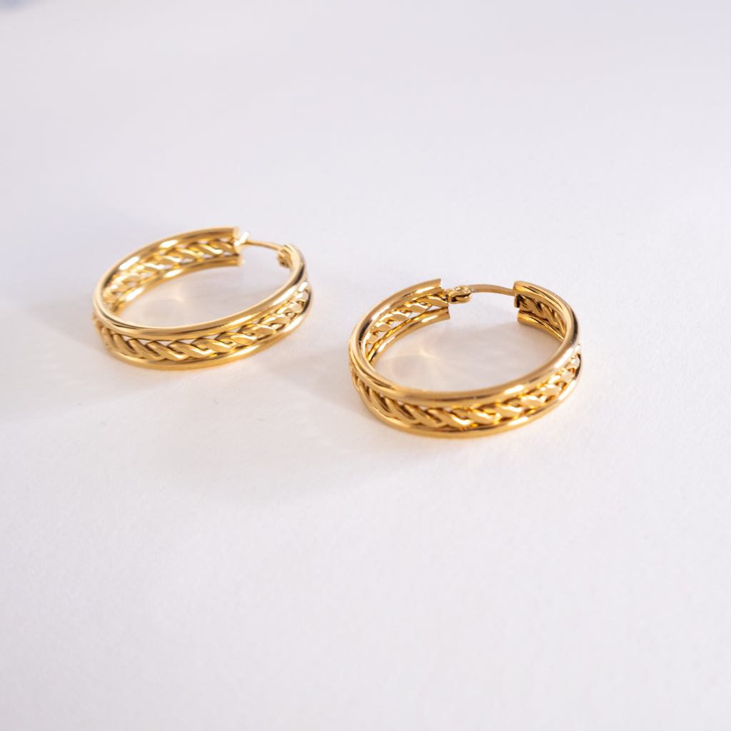 Pair of gold hoop earrings on a white background