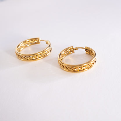 Pair of gold hoop earrings on a white background