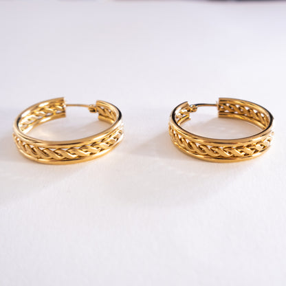 Pair of gold hoop earrings on a white background
