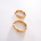 Pair of gold hoop earrings on a white background