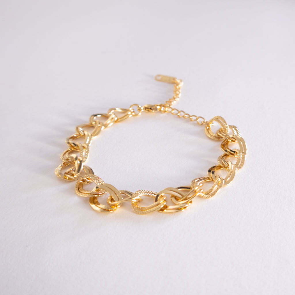 Gold chain bracelet on a white background