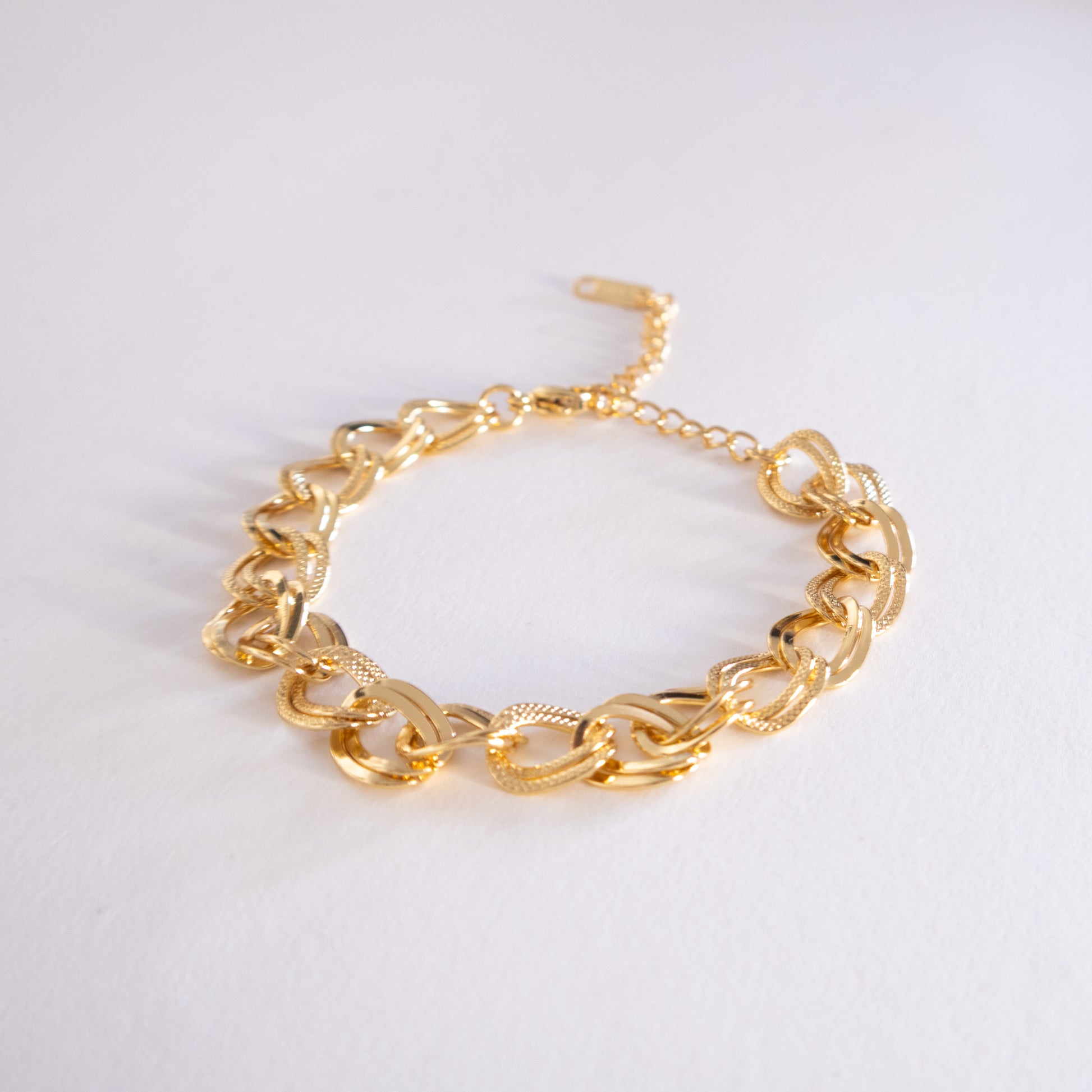 Gold chain bracelet on a white background