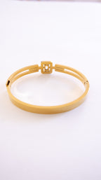 Gold bracelet on a white background