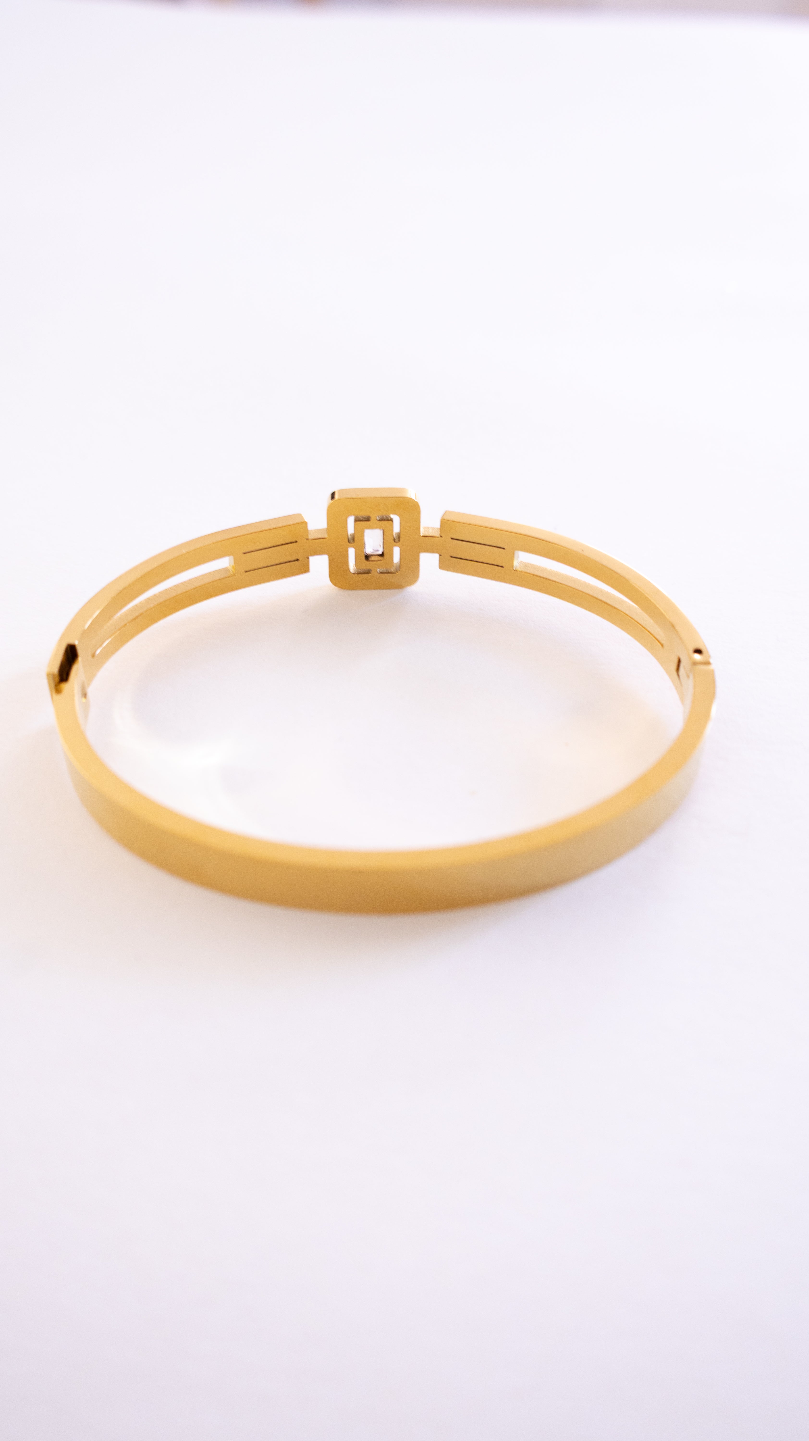 Gold bracelet on a white background