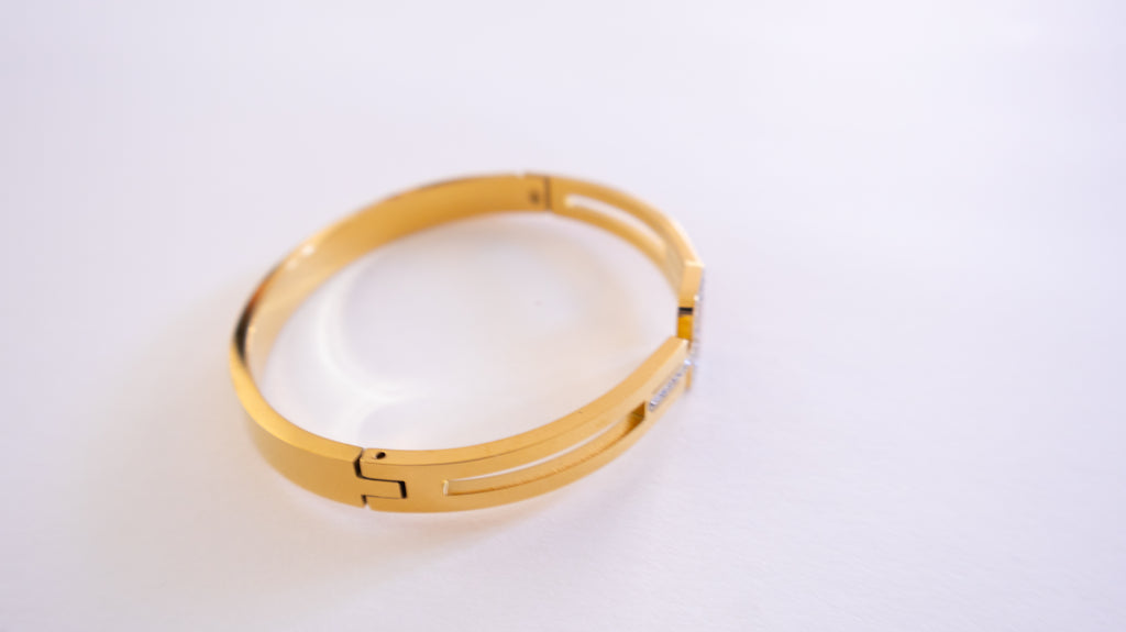 Gold bracelet on a white background