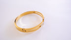 Gold bracelet on a white background