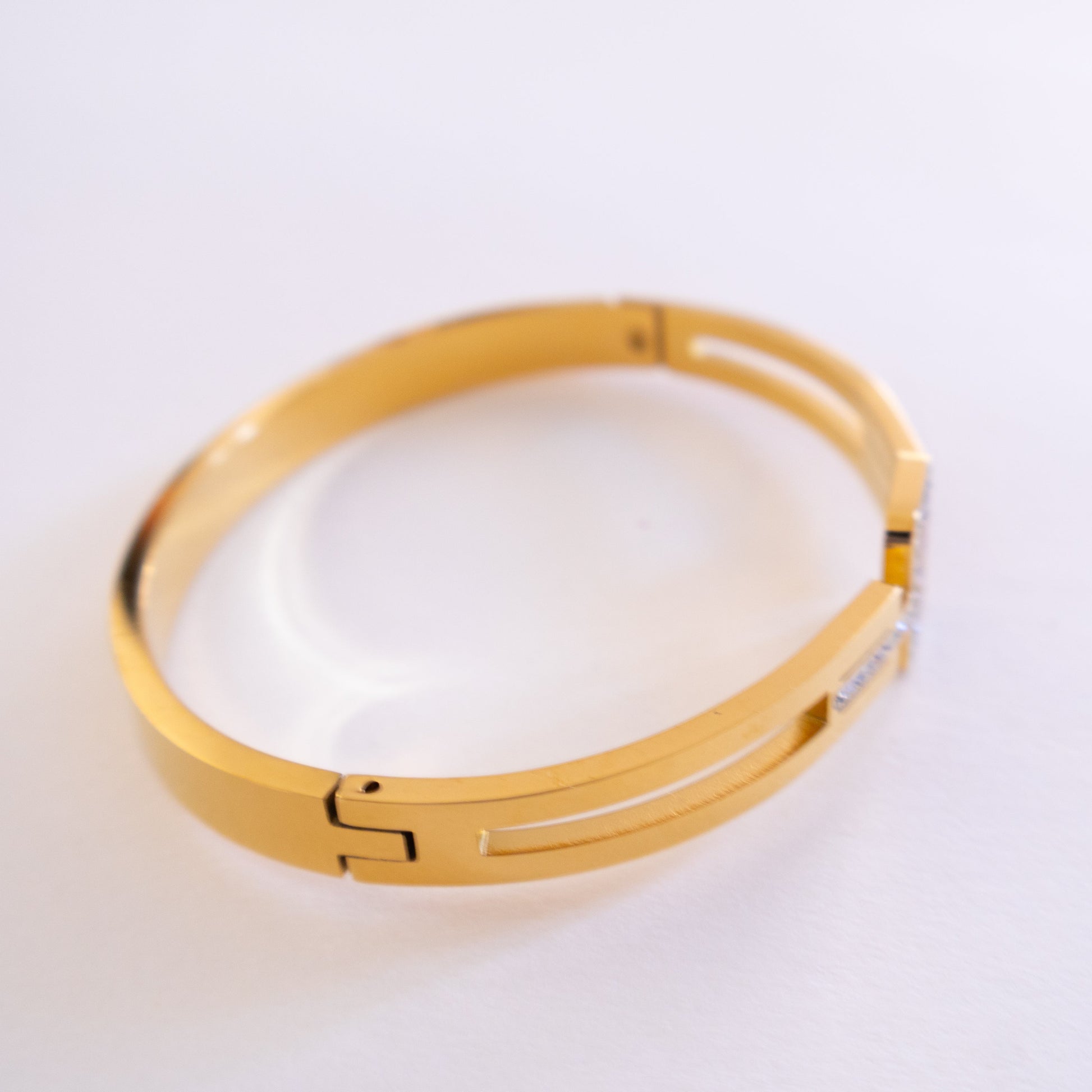 Gold bracelet on a white background