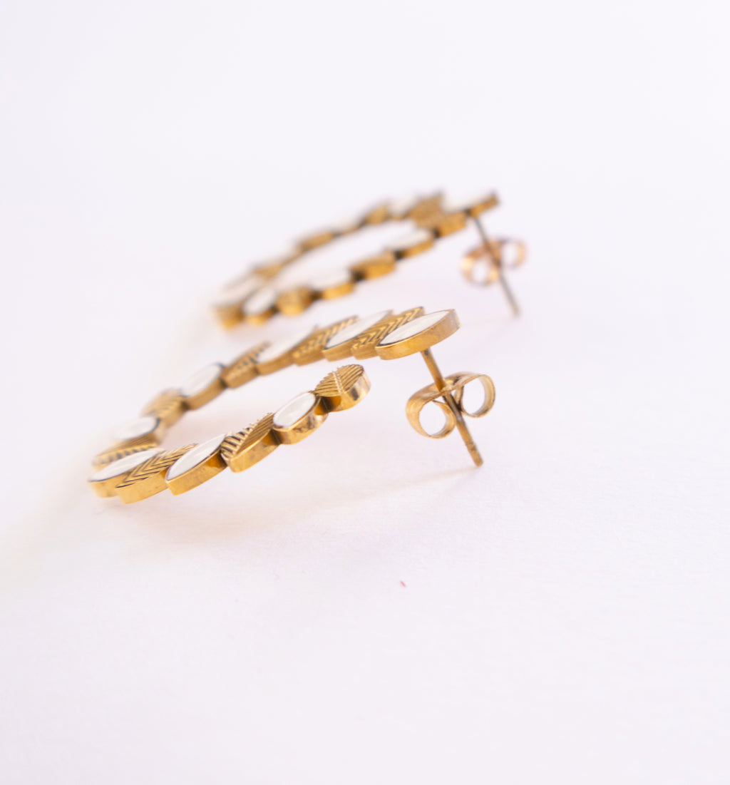 Gold hoop earrings on a white background
