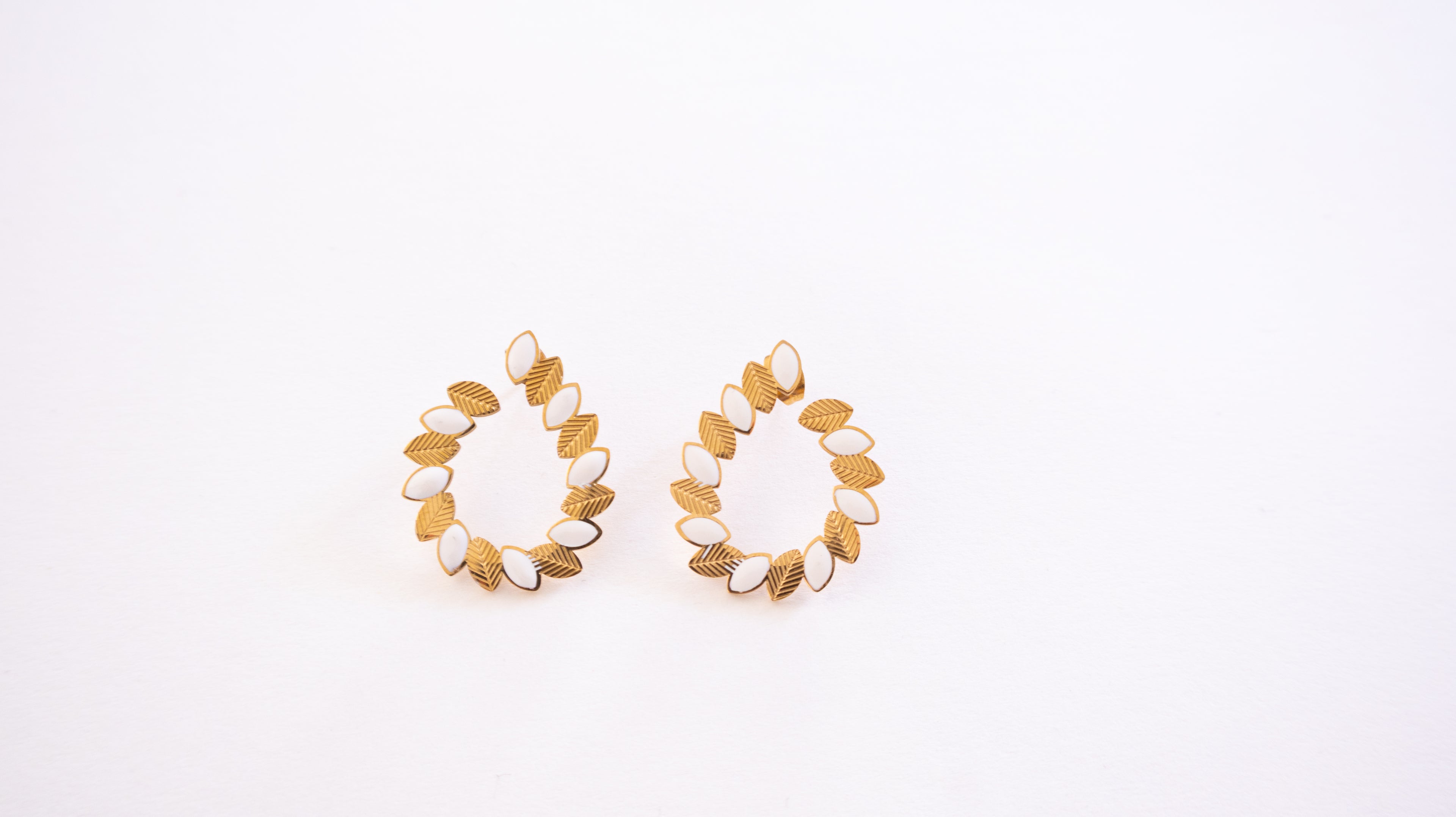 Pair of gold hoop earrings on a white background