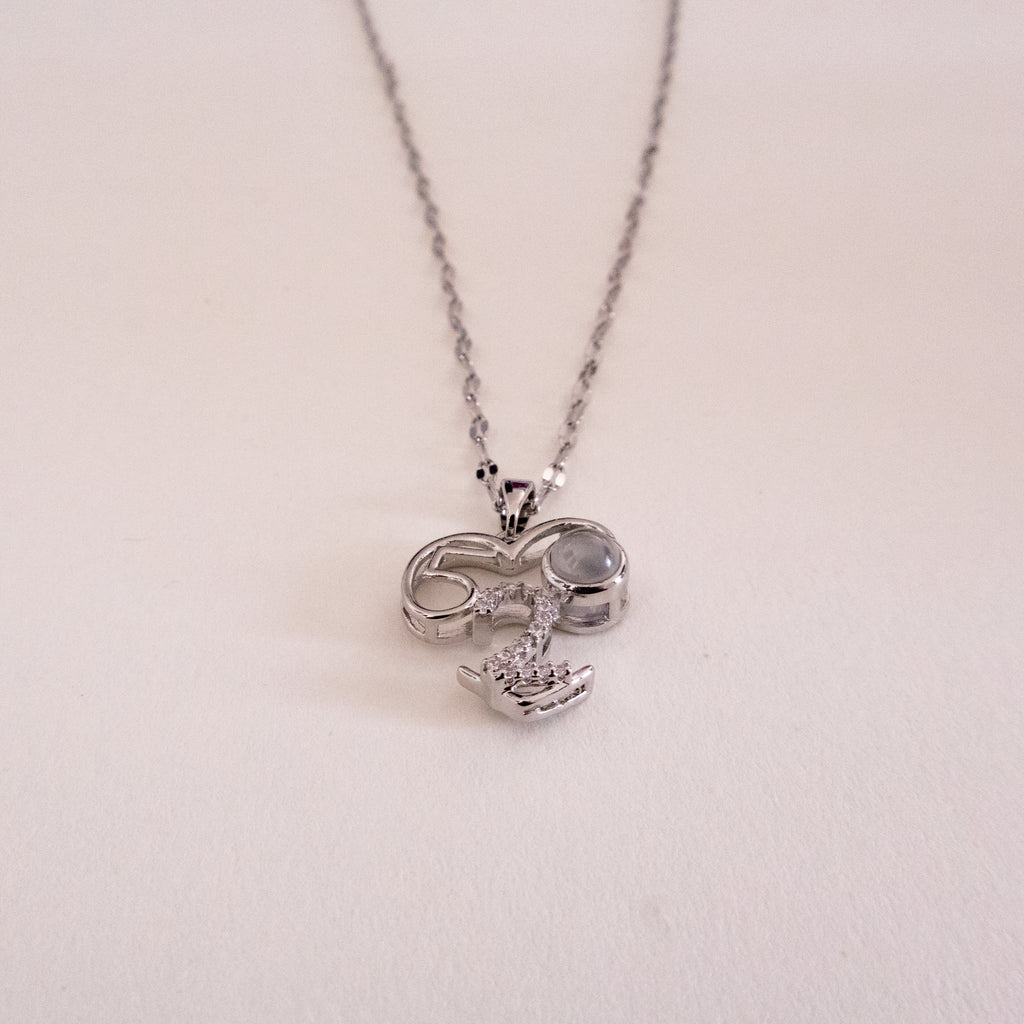 Heart-shaped pendant necklace on a light gray background